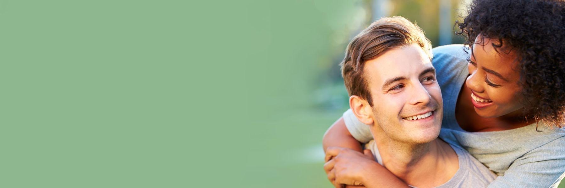 Young couple smiling after getting dental implants in Edmond, OK