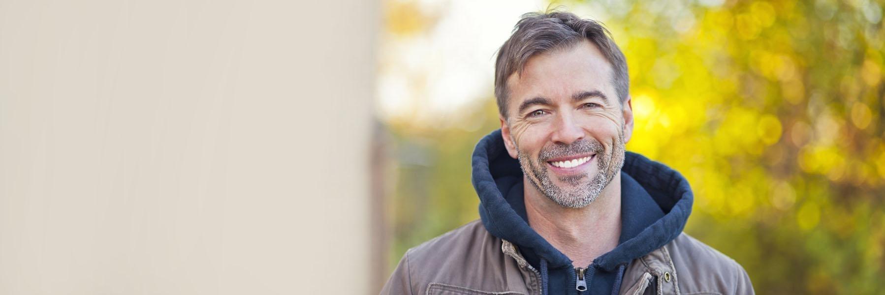 Adult man smiling after gum disease treatment in Edmond, OK