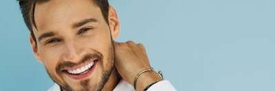 A patient smiling after getting dental implant at Edmond Dental Center