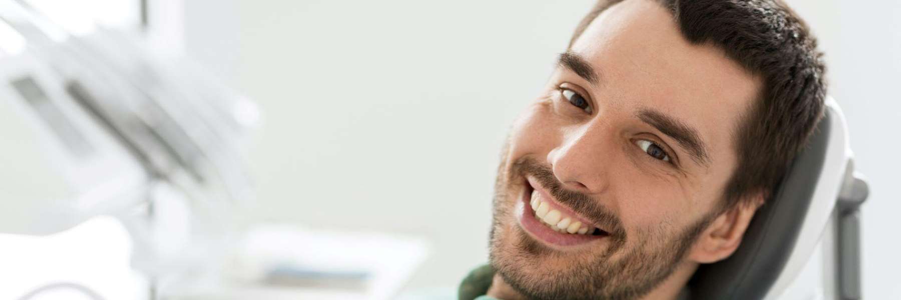A patient smiling after a dental crown in Edmond Dental Center, Edmond, OK.