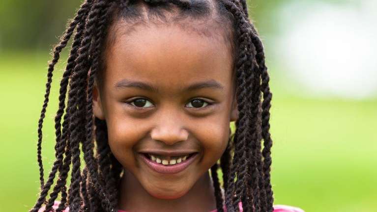 Kid smiling after dental check up and examination at Edmond Dental Center