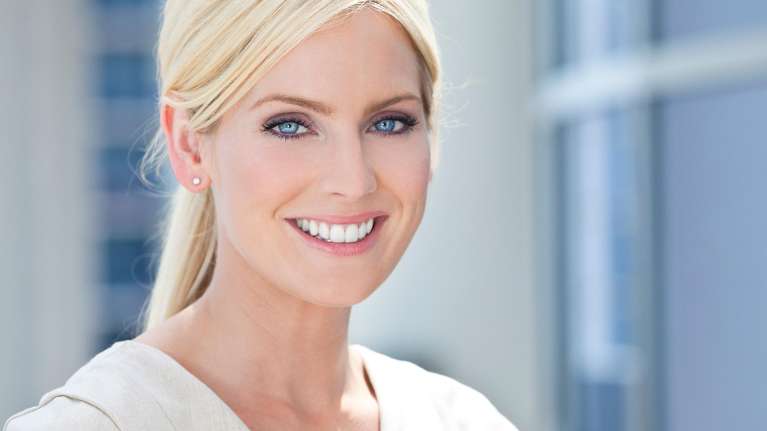 A happy lady after cosmetic dentistry treatment at Edmond Dental Center
