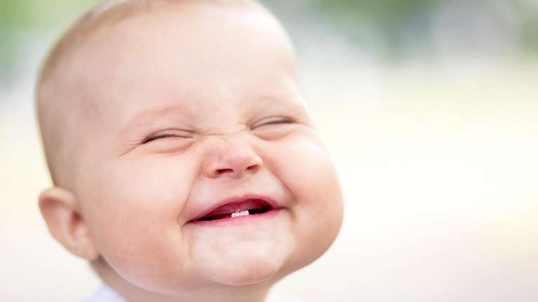 An image of a toddler smiling in Edmond, OK