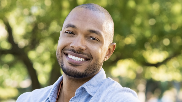 A happy patient after tooth extraction in Edmond, OK