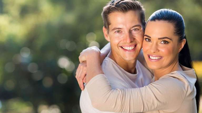Couples embracing after undergoing Cosmetic Dentistry Edmond Dental Center