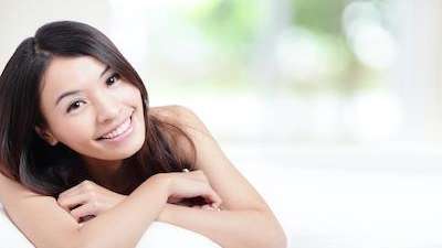 A lady smiling after getting dental crowns at Edmond Dental Center