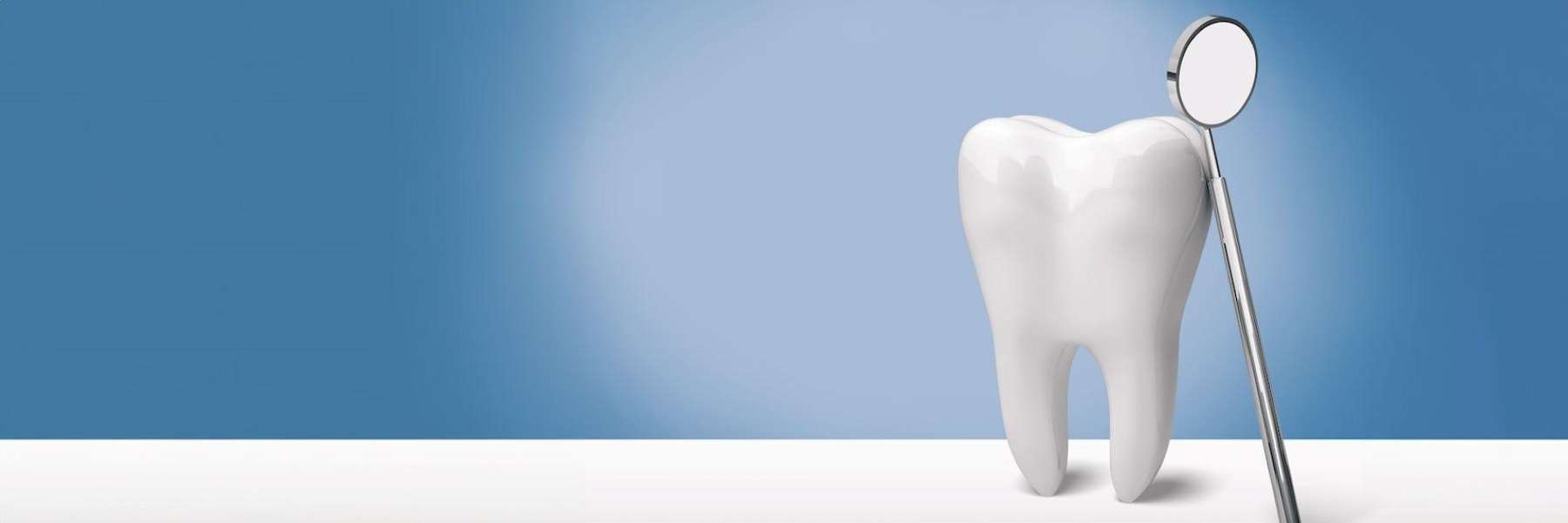 A picture of tooth model and dental mirror in Edmond, OK