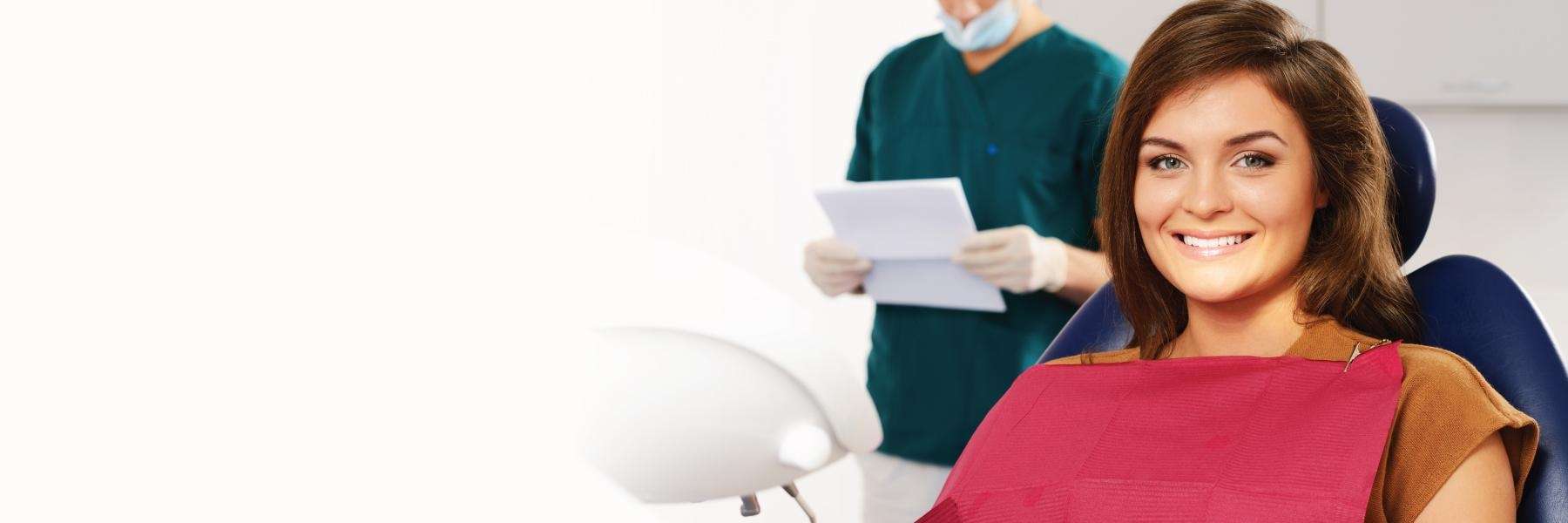 Lady smiling on dental chair after root canal in Edmond, OK