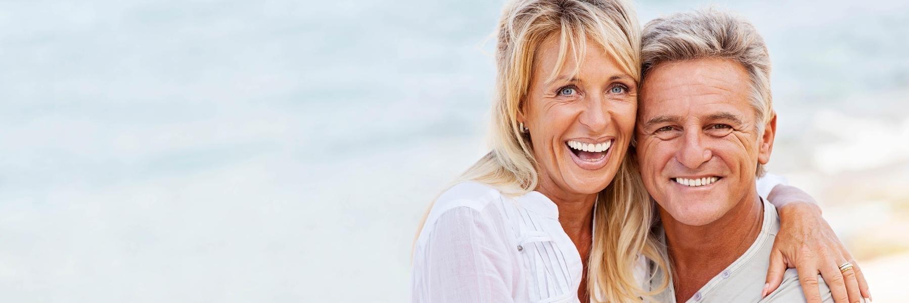 Couple smiling after getting dental implants in Edmond, OK